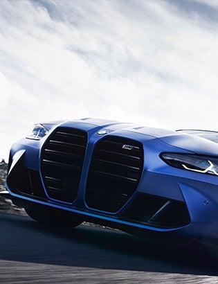 Detail shot of the iconic BMW M kidney grille finished in high-gloss black.