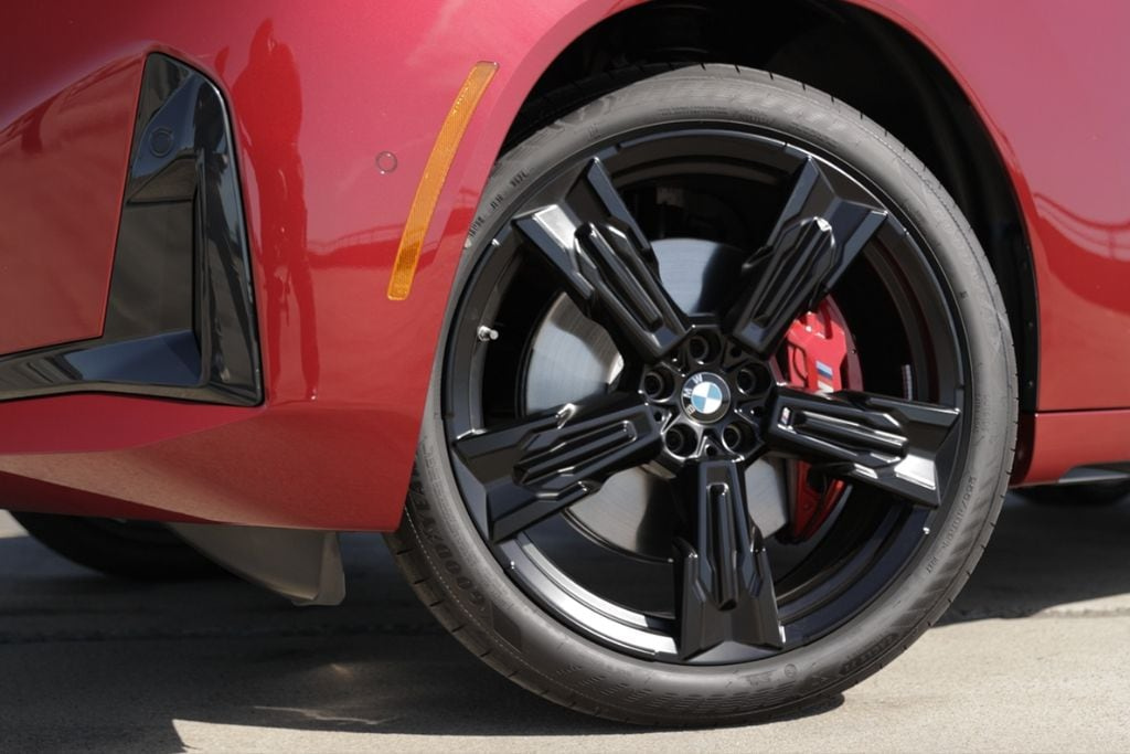 Close-up of the alloy wheel on a red BMW X3 SUV